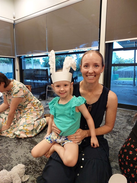 Libraries Easter image mum and daughter sitting on the floor of the library 2025