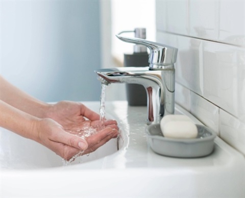 side view person preparing wash their hands sink